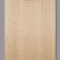 Natural Sitka spruce top with slight curl in outer grain lines and even texture, crafted for clarity and warmth in acoustic builds.
