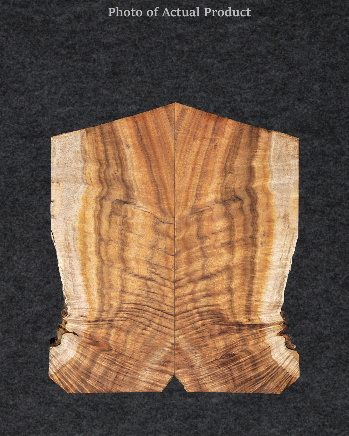 Warm Koa wood guitar top featuring tight curl figuring, amber tones, and bold grain movement.