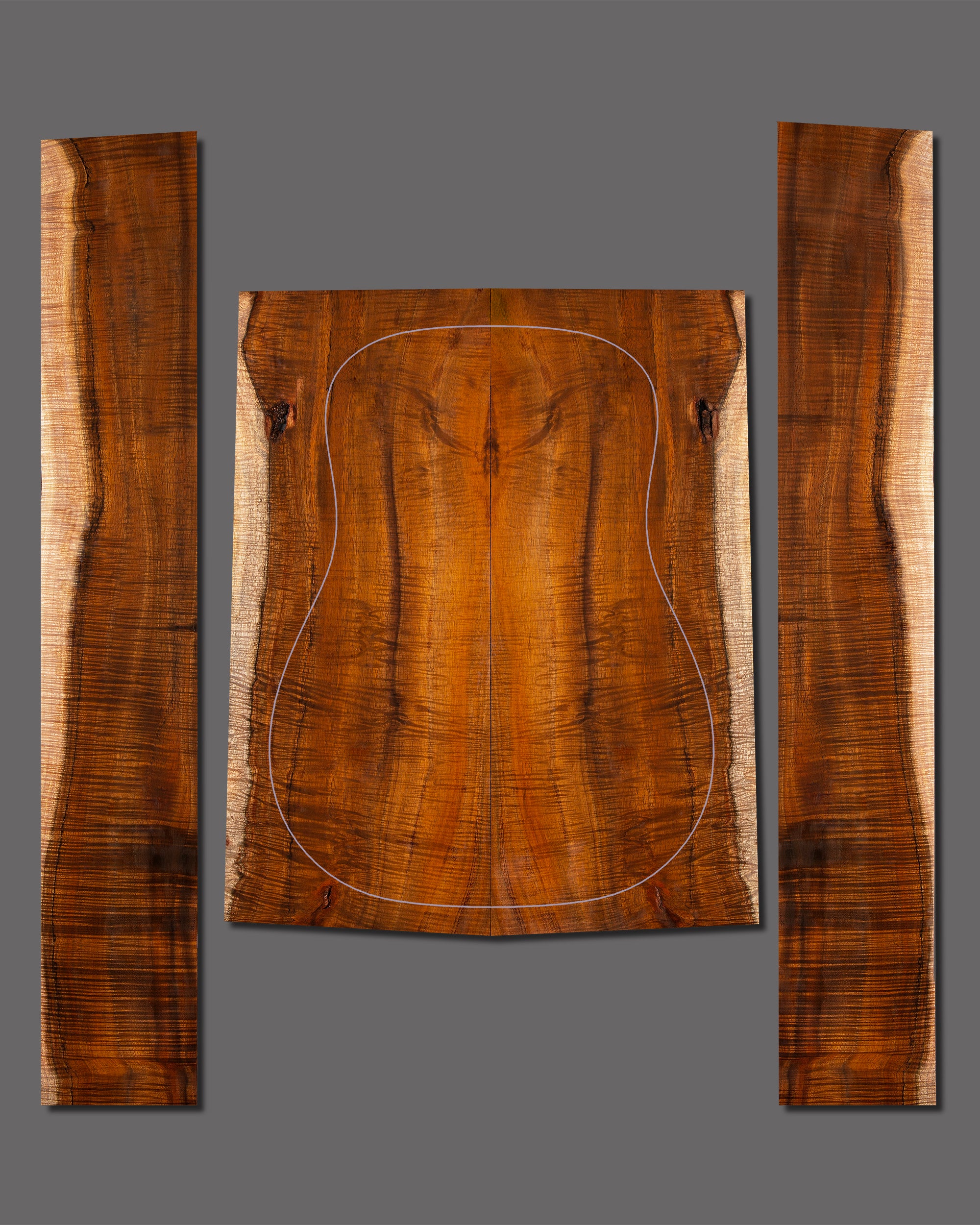 Highly figured Koa guitar back and side set with bold, fiery curl and deep golden hues. Prominent sapwood centre line adds strong visual contrast.