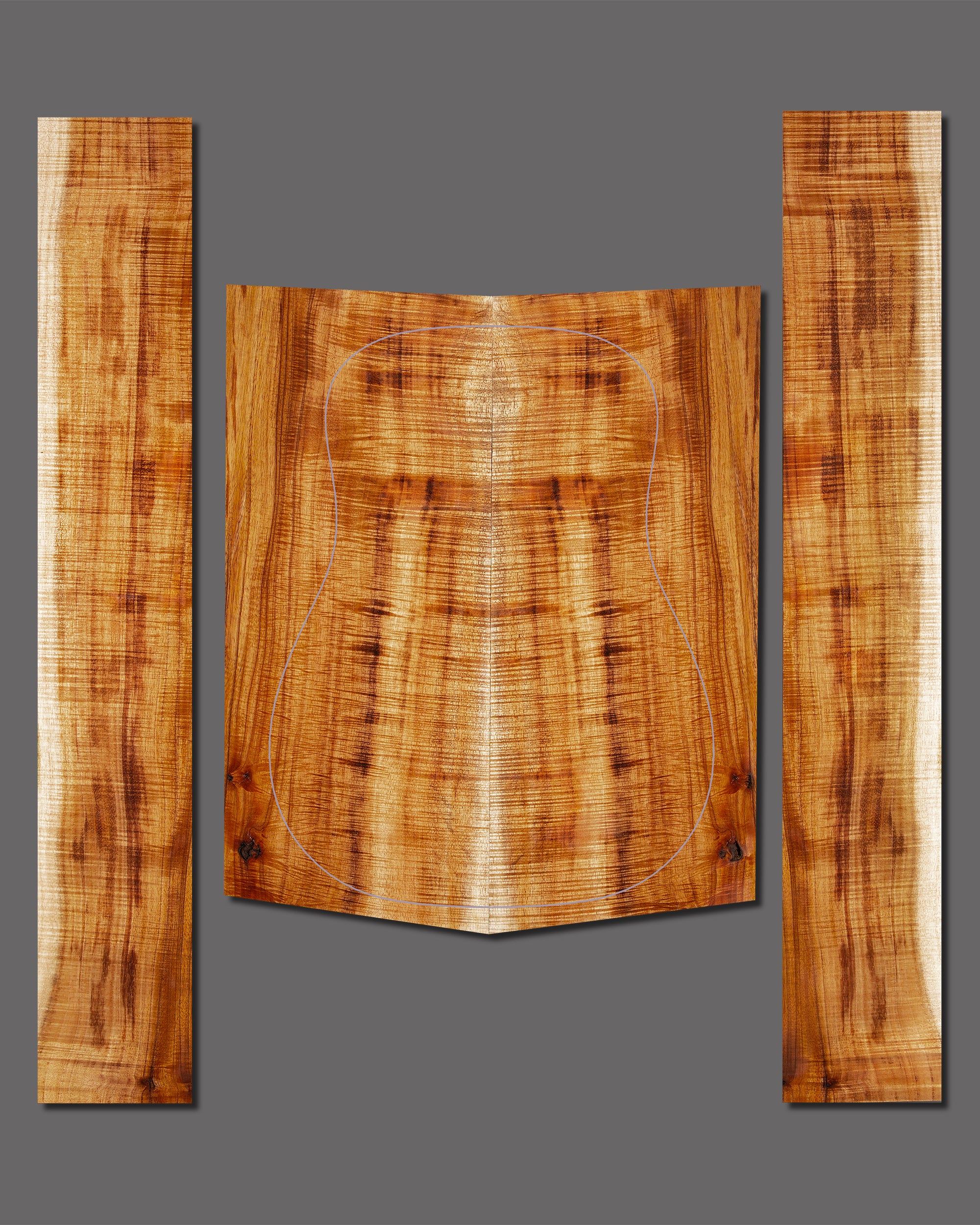 Figured koa back and side set in natural hues with a mild curl pattern. Warm tonewood ideal for custom guitar builds.