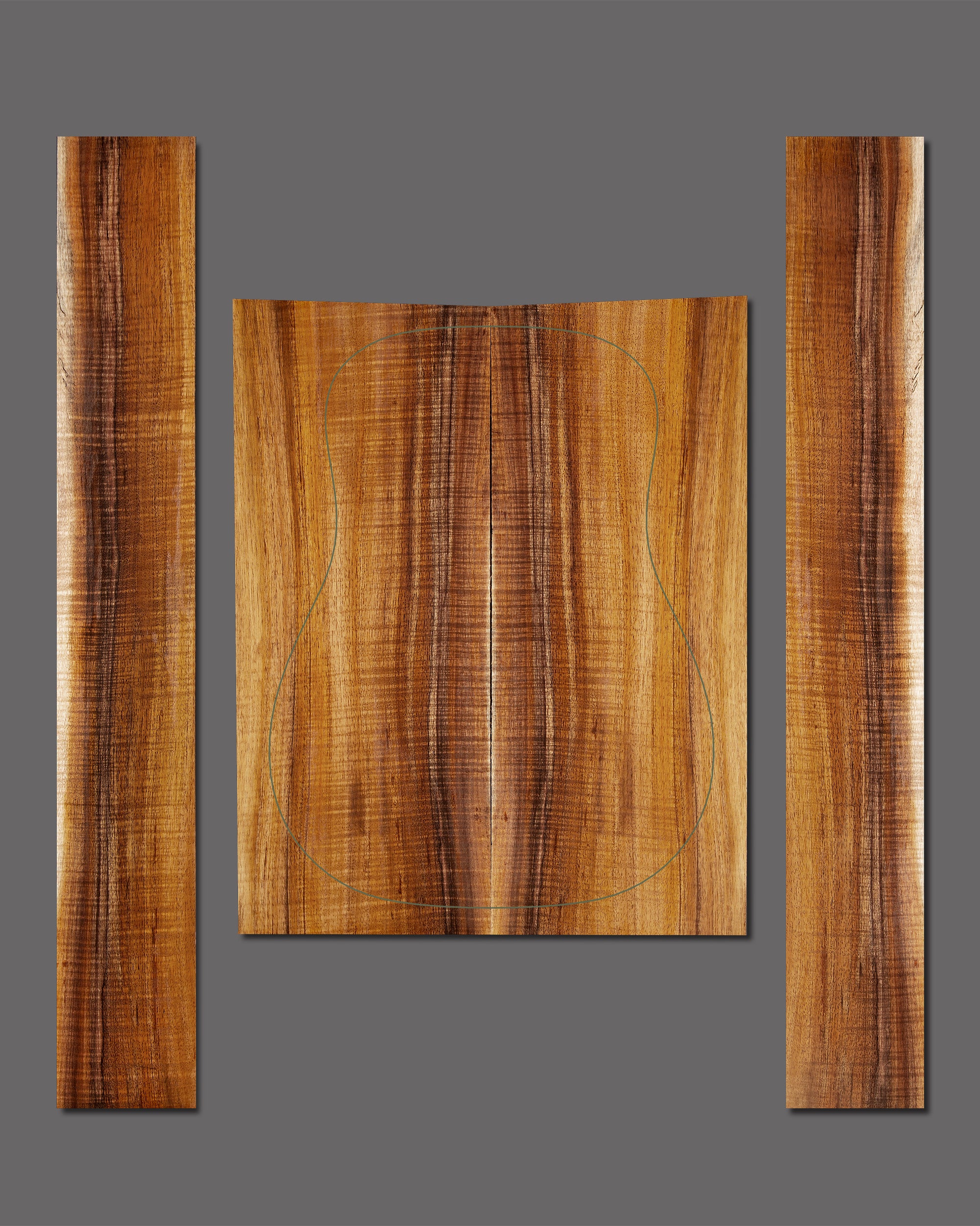 Vibrant figured Koa set with strong flame pattern and dramatic curl. Bright central sapwood flanked by darker grain creates high contrast appeal.