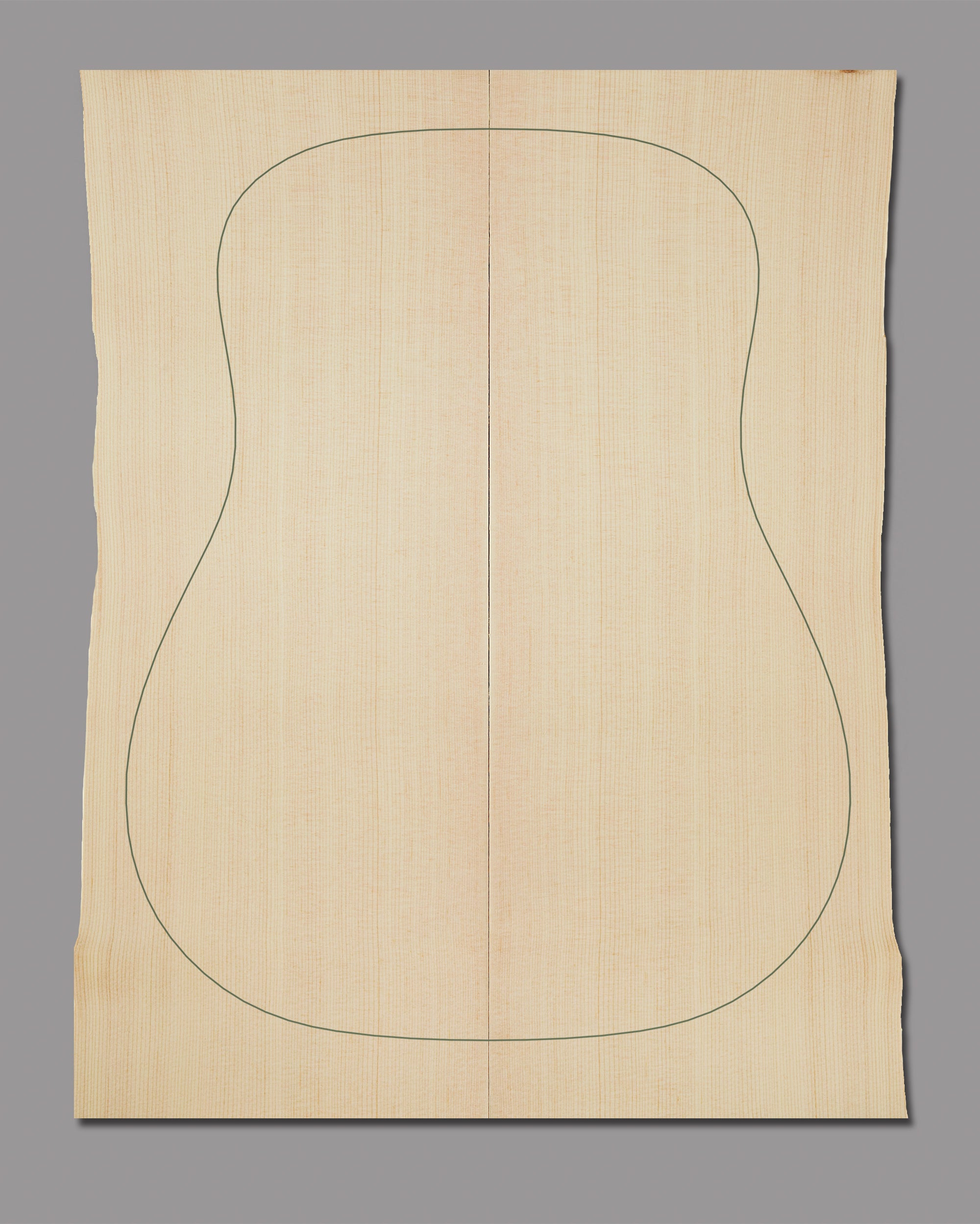 Lutz spruce guitar top with soft golden hues and vertical grain definition.