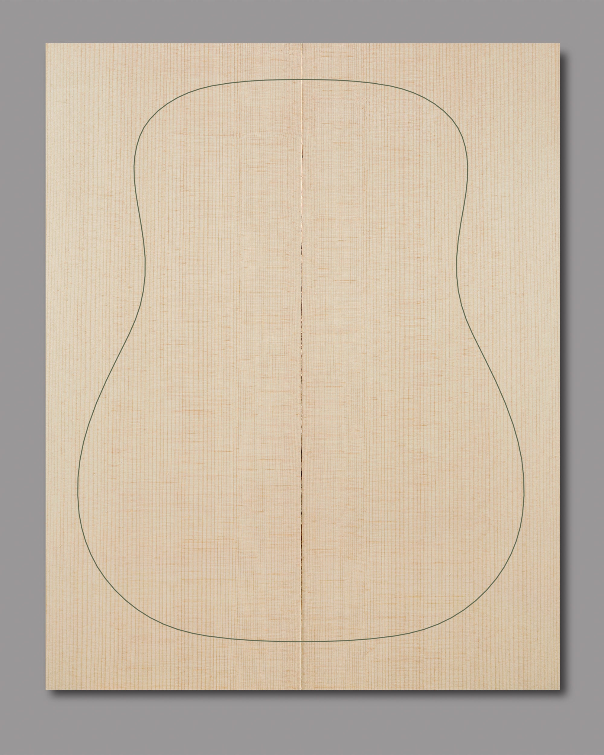 Sonically graded spruce top featuring uniform grain lines and pale golden tone.