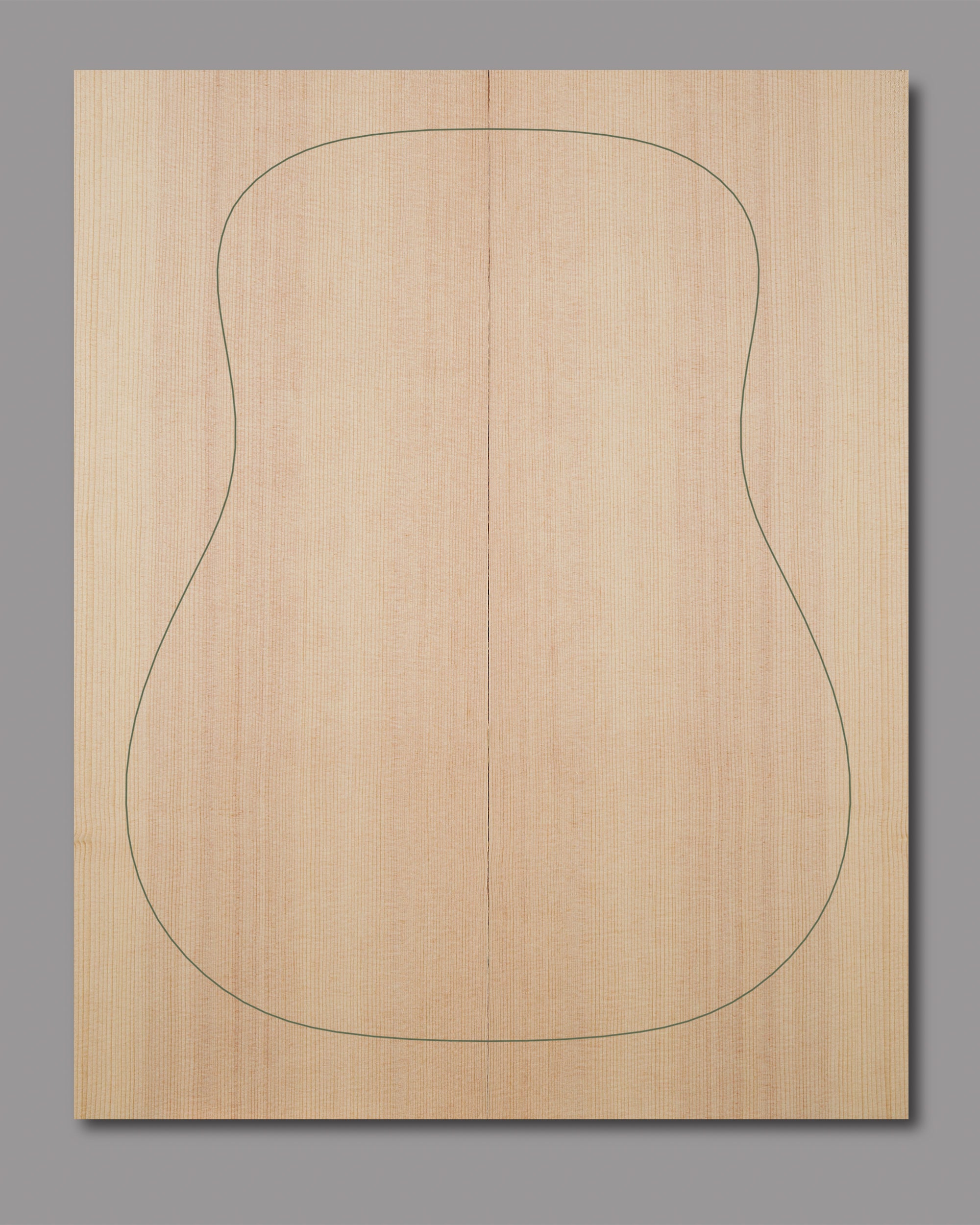 Sitka spruce soundboard with balanced symmetry and subtle golden grain patterns.